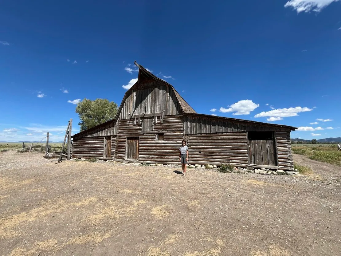 Visitor near historic Mormon Row barn in Grand Teton