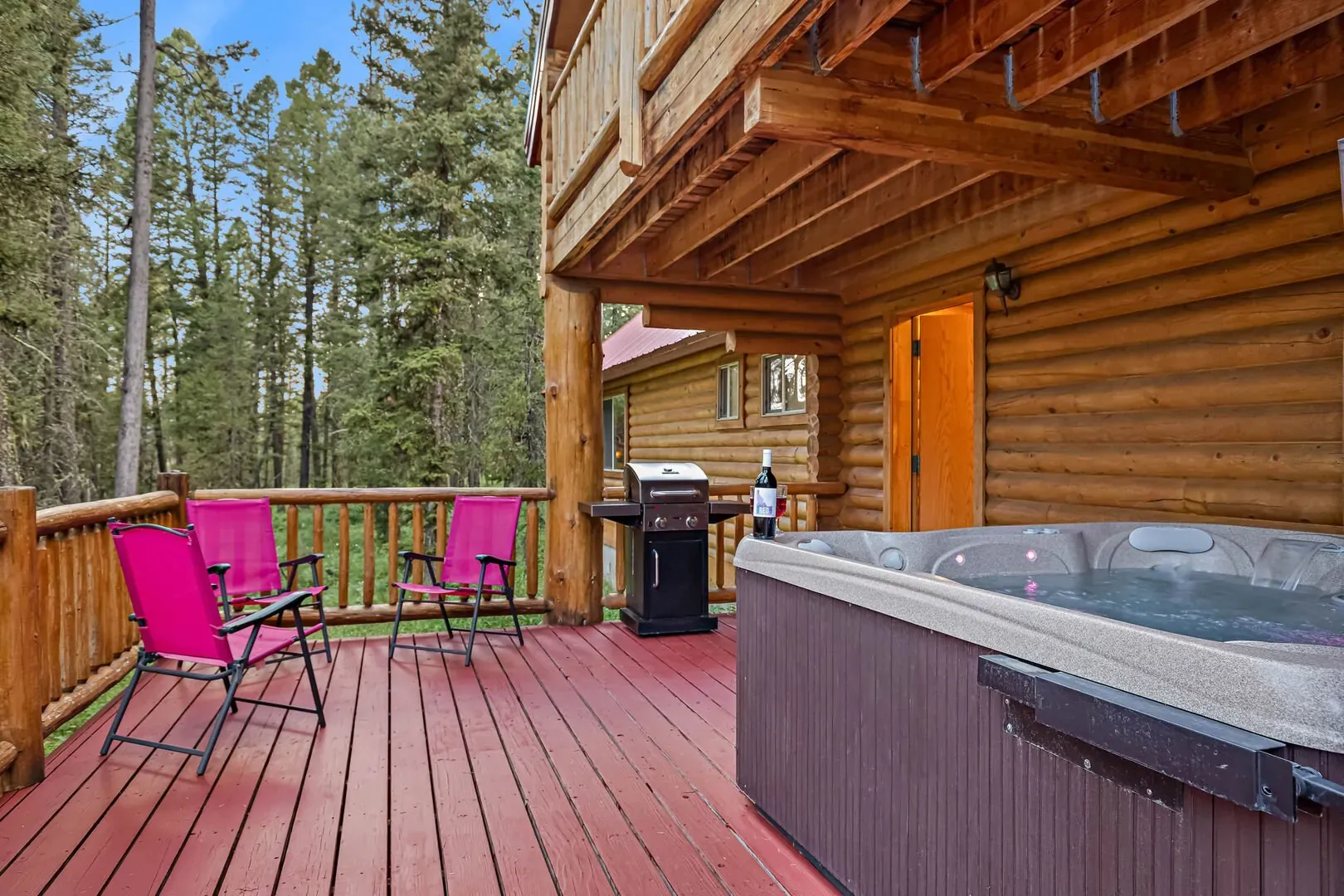 Private hot tub with deck seating — your nightly soak spot after a Yellowstone day