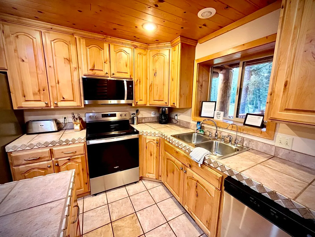 Close-up of the modern stainless steel appliances — dishwasher, oven, and microwave