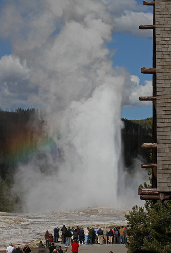 View of Old Faithful erupting from the Old Faithful Inn balcony