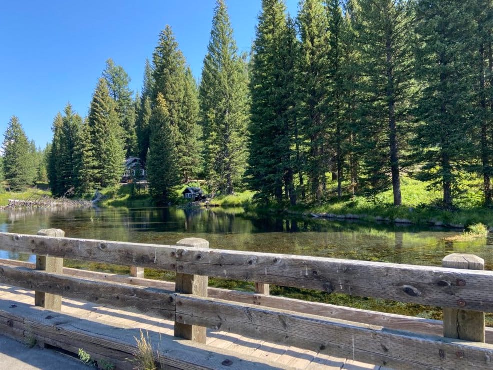 Bridge over Big Springs in Island Park, Idaho in summer with crystal-clear water visible below
