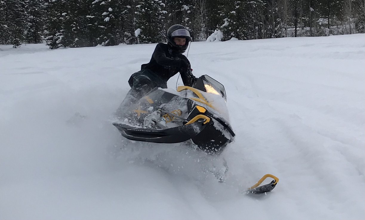 Snowmobiler on groomed trail near Island Park